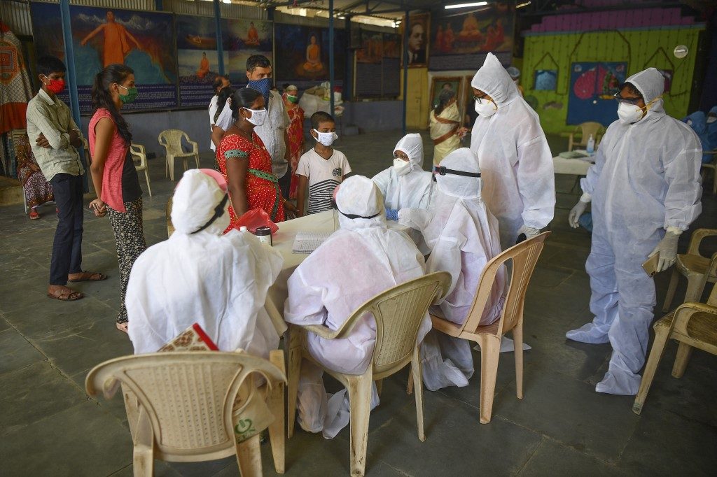 CORONAVIRUS IN INDIA. Doctors and medical staff attend residents at a COVID-19 coronavirus community clinic during a nationwide lockdown imposed as a preventive measure against the COVID-19 coronavirus, in Mumbai on May 19, 2020. File photo by Indranil Mukherjee/AFP 