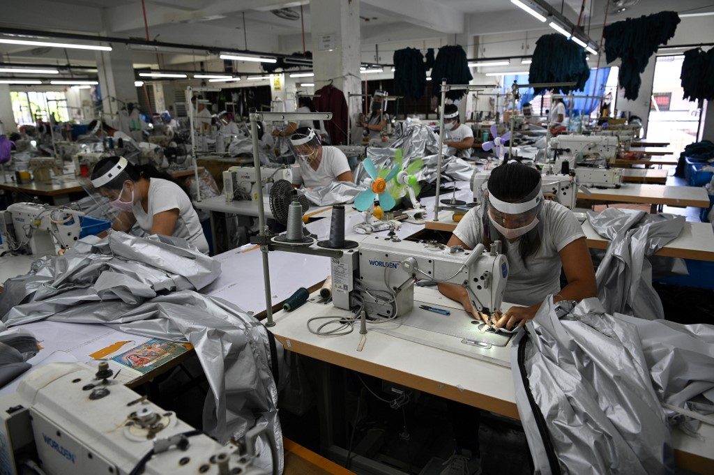 MANUFACTURING. Factory workers make personal protective equipment in Rizal. Photo by AFP  