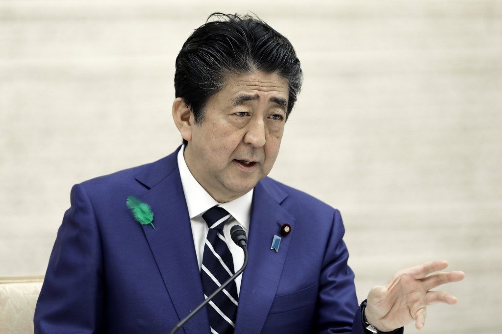 Japan extends virus state of emergency until May 31