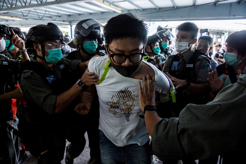 IN PROTEST. Police officers arrest a pro-democracy demonstrator (C) during a pro-democracy protest calling for the city's independence in Hong Kong on May 10, 2020. Photo by Isaac Lawrence/AFP  