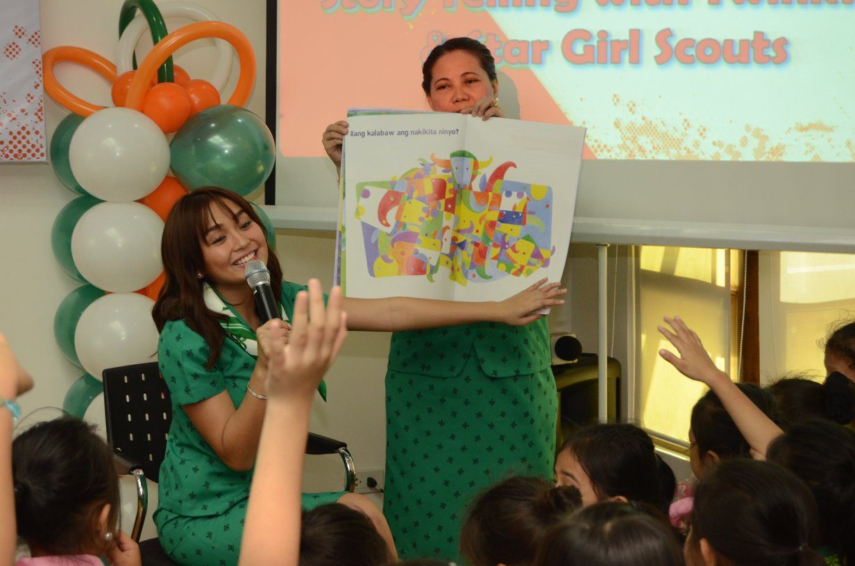 STORYTELLING. Kathryn reads a book to a group of Girl Scouts. Photo from Facebook/Girl Scouts of the Philippines 