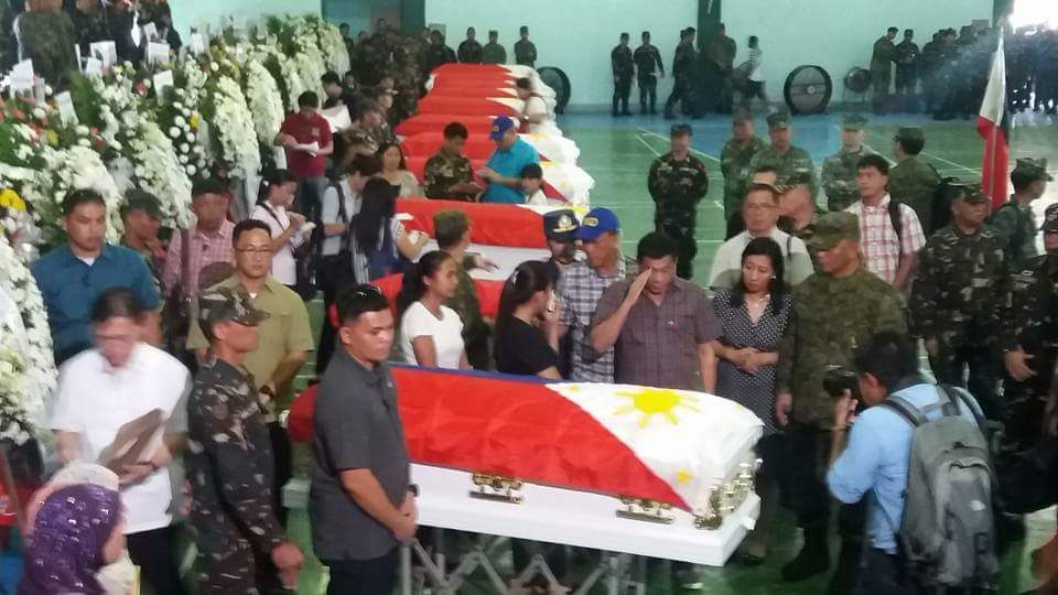 SALUTE. President Duterte salutes the body of a fallen soldier who died during an encounter with the Abu Sayyaf in Zamboanga City. Photo by Richard Falcatan/Rappler 