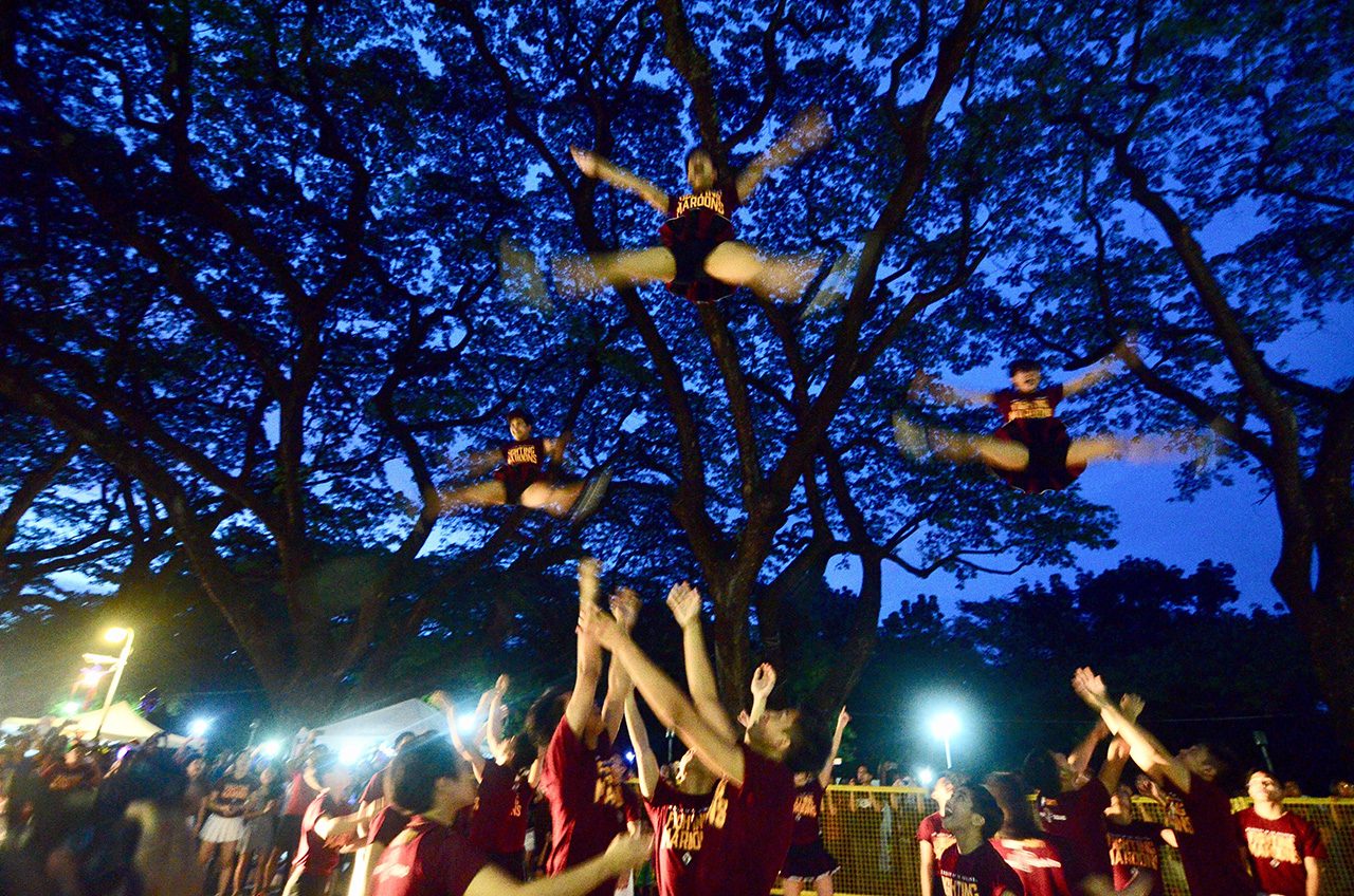 FLY HIGH. The UP Varsity Pep Squad lights up the parade with their stunning performance. Photo by Maria Tan/Rappler   