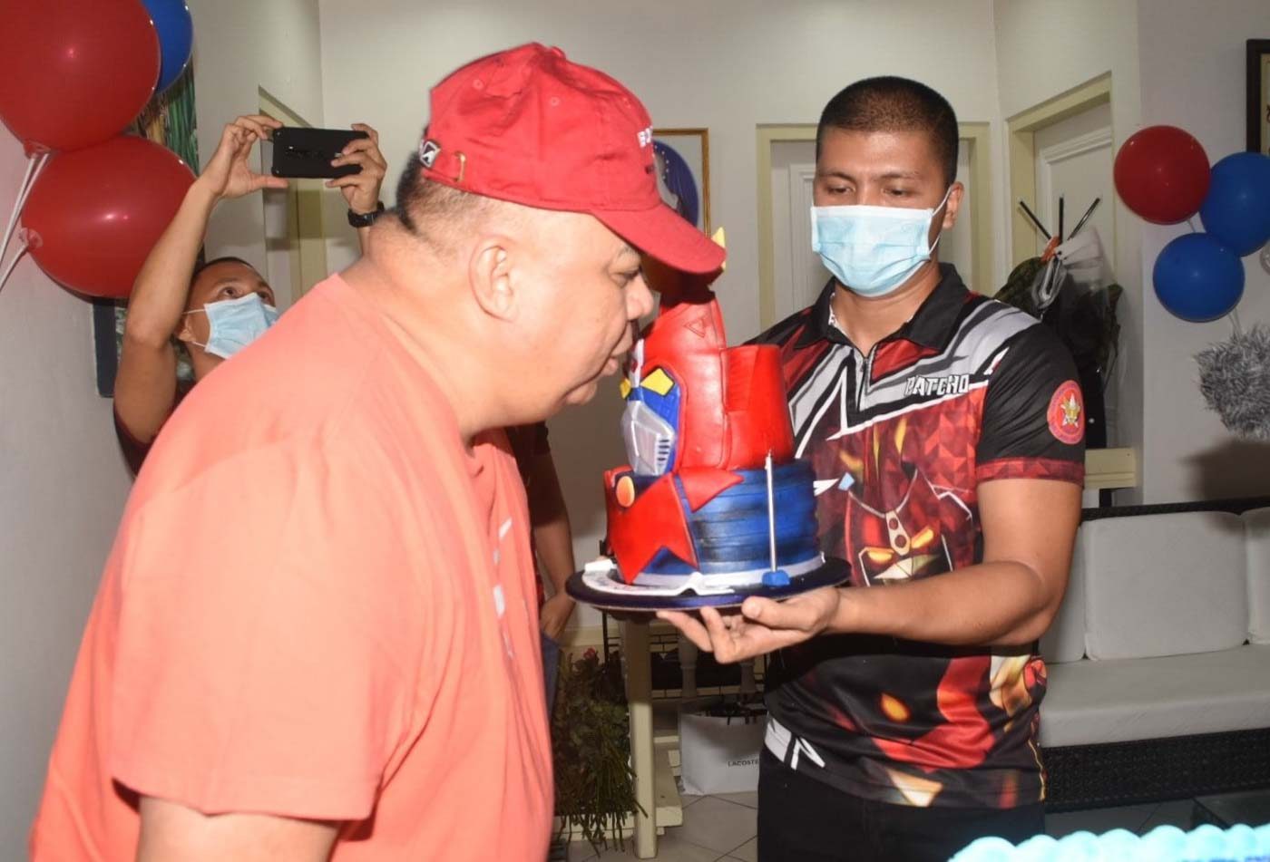 RULES BROKEN. Sinas blows a birthday candle during his surprise birthday celebration on May 8. NCRPO photo 