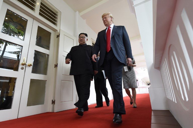 LEADERS. North Korea's leader Kim Jong Un (L) walks with US President Donald Trump (R) at the start of their historic US-North Korea summit, at the Capella Hotel on Sentosa island in Singapore on June 12, 2018. Photo by Saul Loeb/AFP 