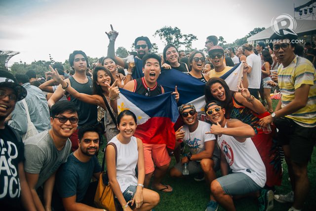 PINOY PRIDE. These Filipino festivalgoers proudly display the Philippine flag. 