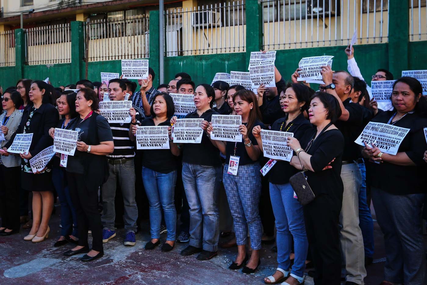 PROTEST. Employees of the National Food Authority stage an early morning Black Monday Protest inside their headquarters in Quezon City to express their support to farmers in view of the recent enactment of the rice tarifficaton law which they say will be unfavorable and a burden to farmers. Photo by Jire Carreon/Rappler      