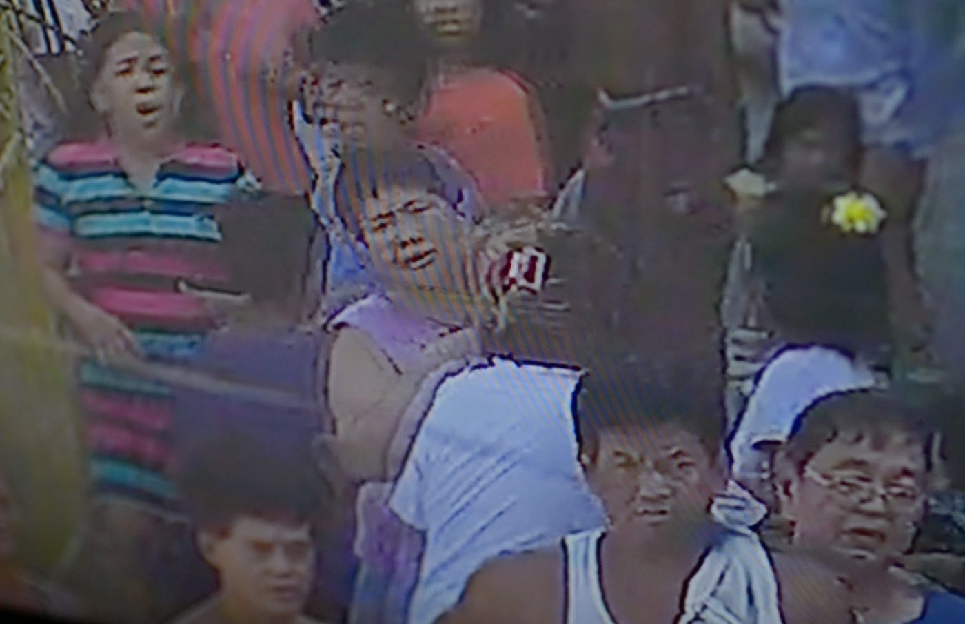 CHAOS. Rosana Brondial is caught in the barangay CCTV, after seeing her 13-year-old son Jayross sprawled on the street. It’s not even a year since she lost an older son. Screen grab from the CCTV of Barangay 103, Pasay City. 