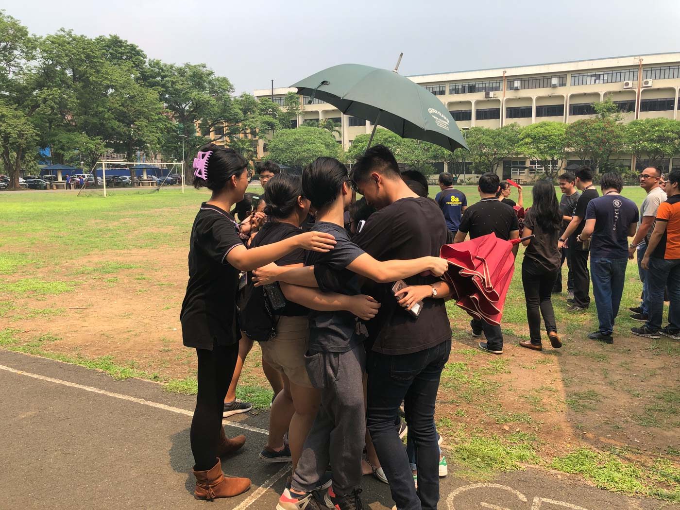 GROUP HUG. Students come together for a group hug after staging a protest on campus on May 23, 2019. Photo by Sofia Tomacruz/Rappler  