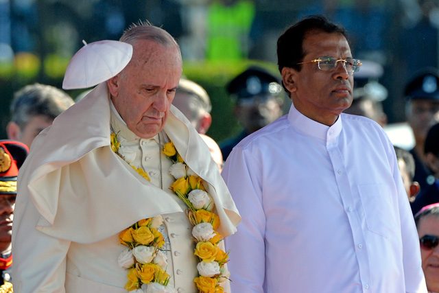 WINDY DAY. Pope Francis' skullcap flies due to a blow of wind as he listens to the national anthem flanked by Sri Lankan President Maithripala Sirisena (R) during a welcome ceremony at Colombo airport, in Colombo, Sri Lanka, January 13, 2015. Photo by Ettore Ferrari/EPA