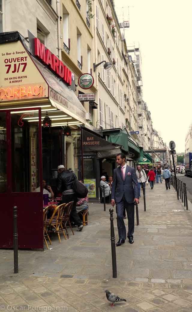 Well-dressed man walking along Rue Montorgueil 