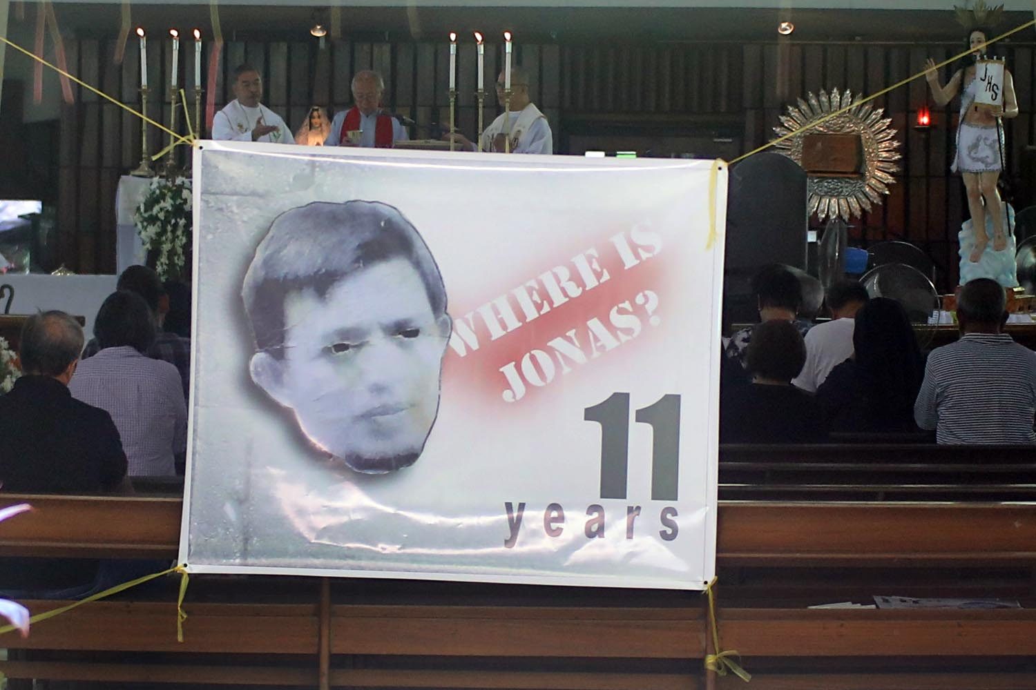 MORE THAN A DECADE. A streamer of missing activist Jonas Burgos hangs at the main entrance of UP Diliman Church to mark the 11th year of his abduction. File photo by Darren Langit 