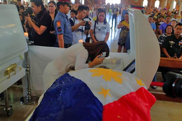 LAST EMBRACE. Ligaya Otaza hugs the coffin of her husband, Mayor Dario Otaza of Loreto, Agusan del Sur, who was kidnapped and slain along with their son Daryl by the New People's Army in their home in Barangay Baan, Butuan City. Their bodies were later found the following day, hog tied and riddled with bullets. Photo by Bobby Lagsa/Rappler 