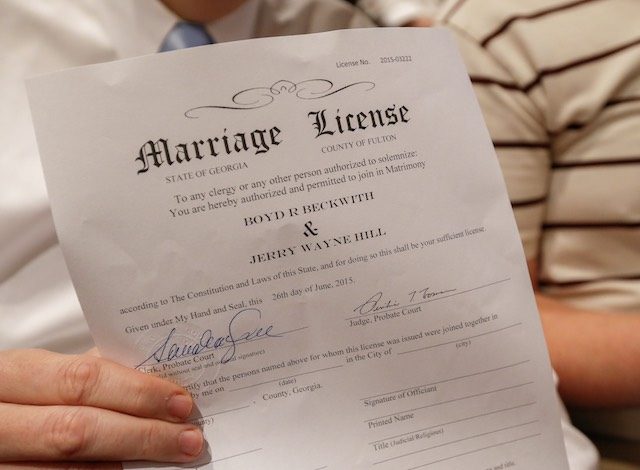 GOING LEGAL. Boyd Beckwith holds his marriage license with his soon-to-be spouse Jerry Hill (R) during a mass wedding ceremony at the Fulton County Government Center in Atlanta, Georgia, USA, June 26, 2015. Erik S Lesser/EPA 