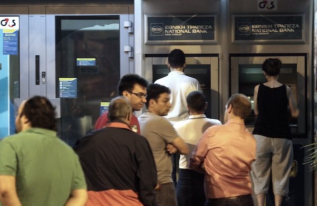 CASHING OUT. People wait in a queue to withdraw money from the ATM outside a branch of Greece's National Bank in Athens, Greece, June 27, 2015. Simela Pantzartzi/EPA 