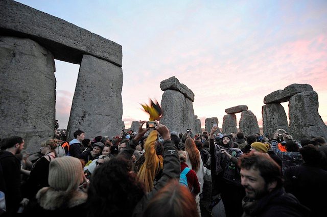 EARLY MORNING PARTY. Revelers welcome the dawning of the summer solstice through cloudy skies, at the historic world heritage site of Stonehenge near Salisbury, Whiltshire, Britain, June 21, 2015. Gerry Penny/EPA 