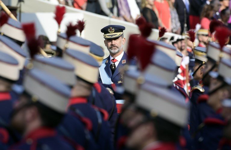 PRAYING FOR UNITY. Spain's King Felipe VI reviews the troops during the Spanish National Day military parade in Madrid on October 12, 2017. Photo by Javier Soriano/AFP   