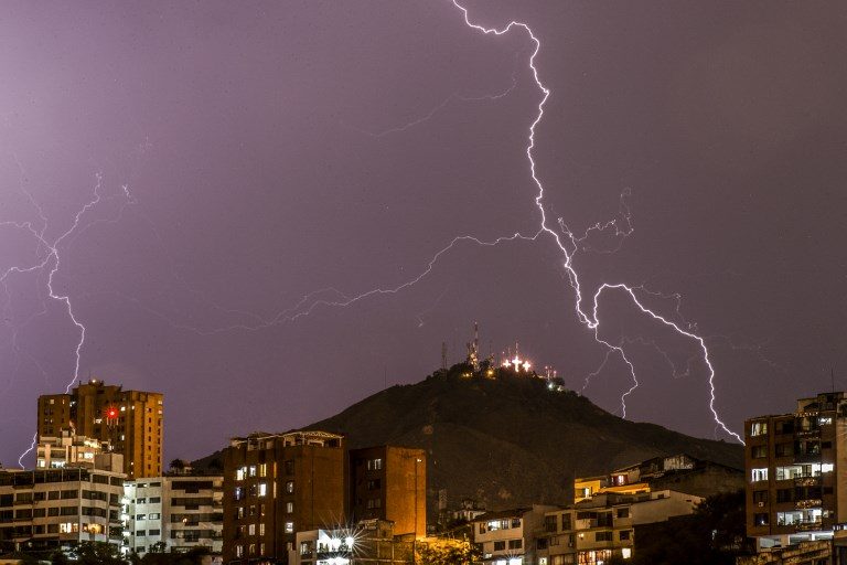 SKY 'DOODLE'. Lightning strikes over the 'Cerro de las Tres Cruces' west of Cali, Colombia, during a thunderstorm on October 9, 2017. Photo by Luis Robayo/AFP   