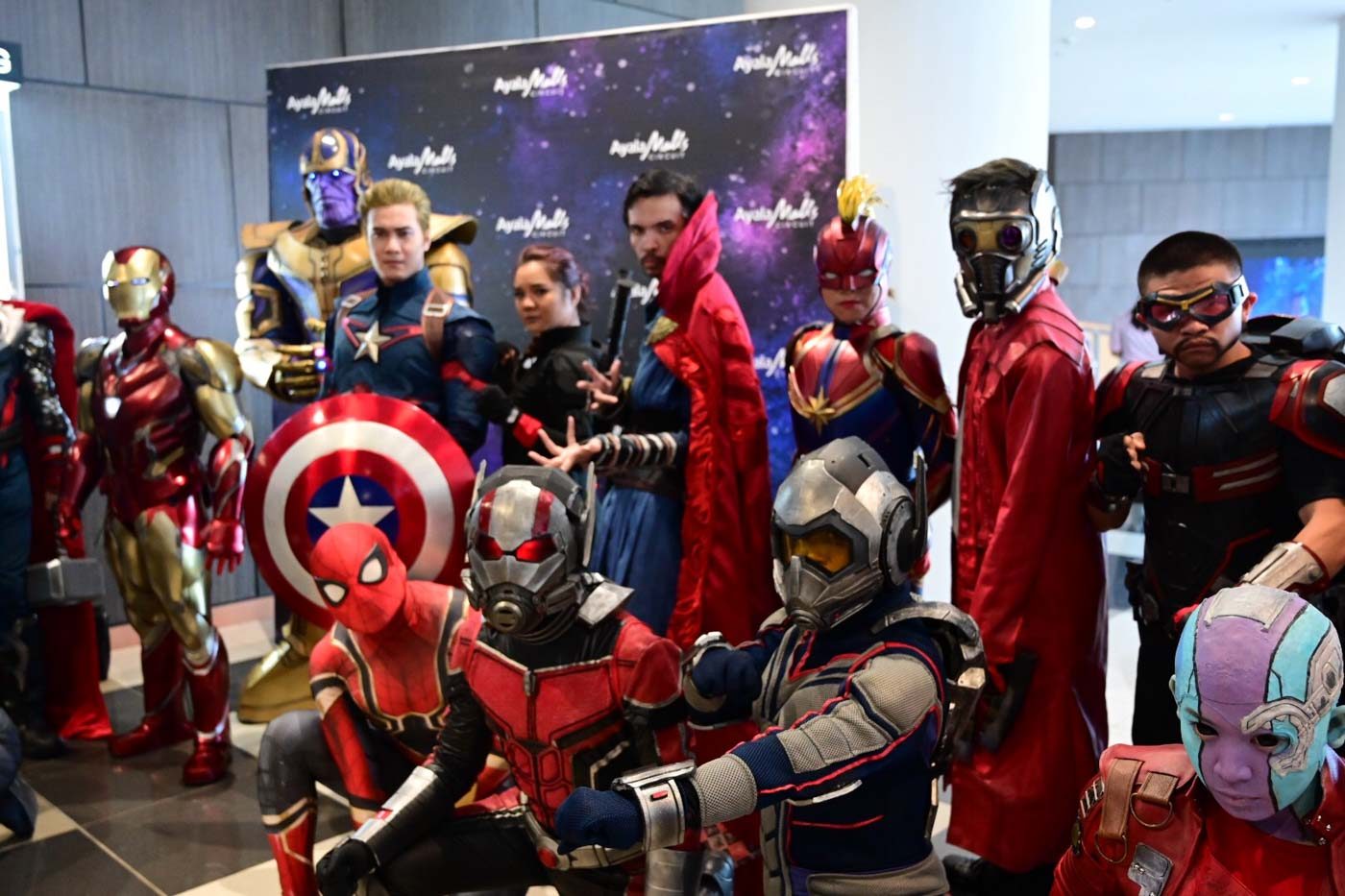 ASSEMBLE. Cosplayers pose for photos before the movie. 