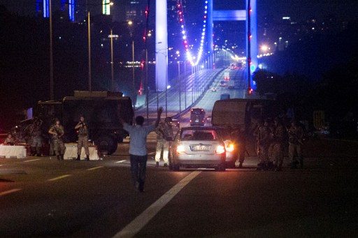 HANDS UP. A man approaches Turkish military with his hands up at the entrance to the partially shut down Bosphorus bridge in Istanbul on July 16, 2016. Photo by Gurcan/AFP 