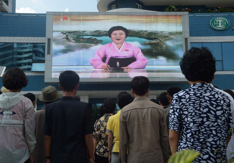 PUBLIC ANNOUNCEMENT. Residents watch a big video screen on Mirae Scientists Street in Pyongyang showing newsreader Ri Chun-Hee as she announces the news that the country has successfully tested a hydrogen bomb on September 3, 2017. Photo by Kim Won-Jin/AFP 