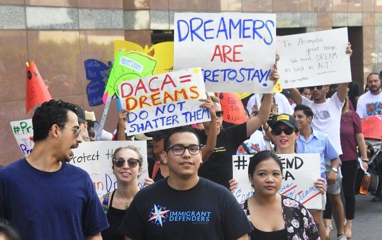 DREAMERS. In this file photo, young immigrants and supporters walk while holding signs during a rally in support of the Deferred Action for Childhood Arrivals program held in Los Angeles, California, on September 1, 2017. File photo by Frederic J. Brown/AFP 