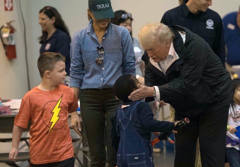 Trump visits evacuees at shelter in storm-battered Houston