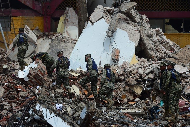 RESCUE. Mexican Navy members walk amid debris of the Town Hall building which partially collapsed following a magnitude 8.2 earthquake that hit Mexico's Pacific coast, in Juchitan de Zaragoza, state of Oaxaca, on September 8, 2017. Photo by Ronaldo Schemidt/AFP  