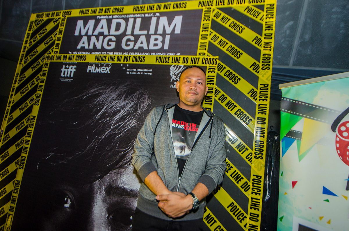DIRECTOR. Director Adolfo Alix Jr stands in front of the poster of his film. 