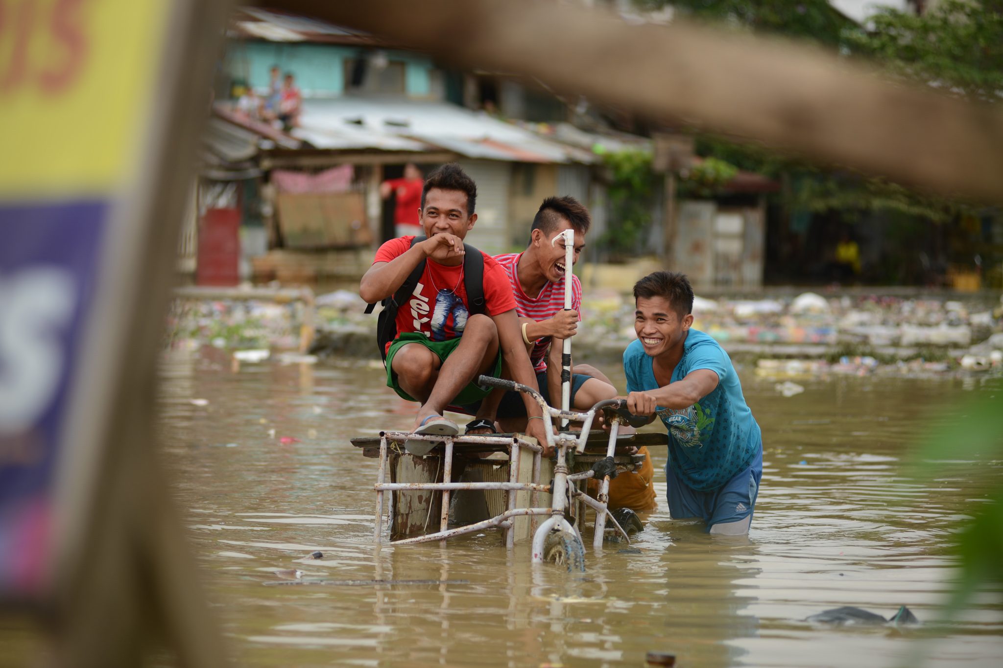 MONSOON RAINS. Men navigate through a flooded area during the Habagat on August 14 in Marikina City, Philippines. Photo by Martin San Diego/Rappler   