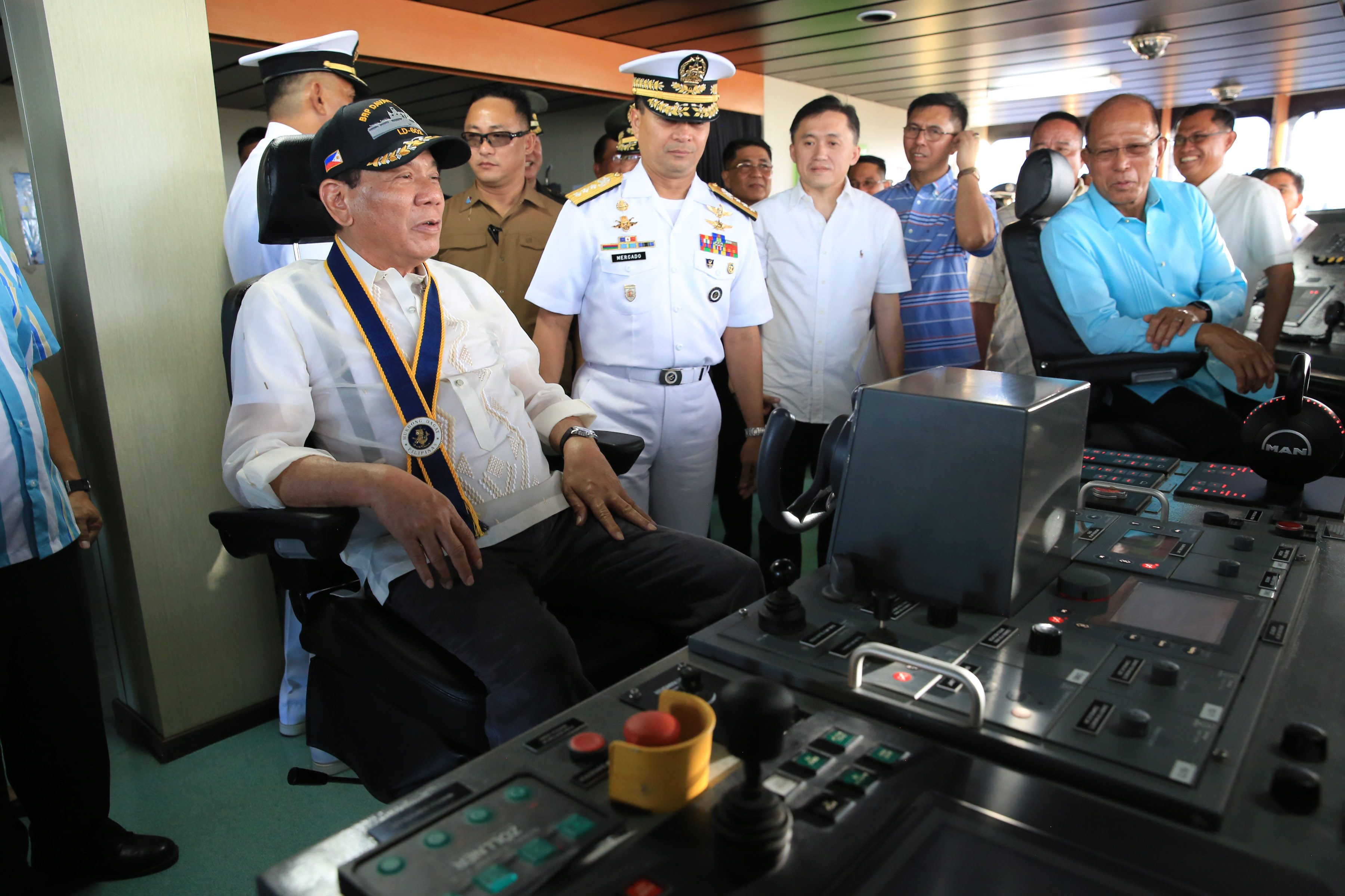 MAN AT THE HELM. President Rodrigo Duterte takes a seat at the ship's bridge. Photo from Presidential Photo
 
