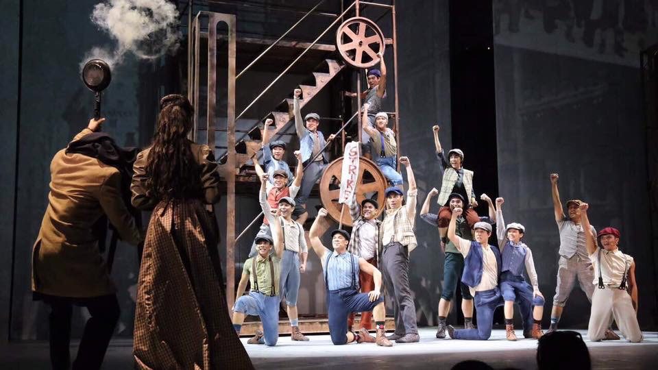 PRODUCTION DESIGN. 'Newsies' features set design by Ed Lacson and lighting design by Martin Esteva. Photo courtesy of 9 Works Theatrical and Globe Live 