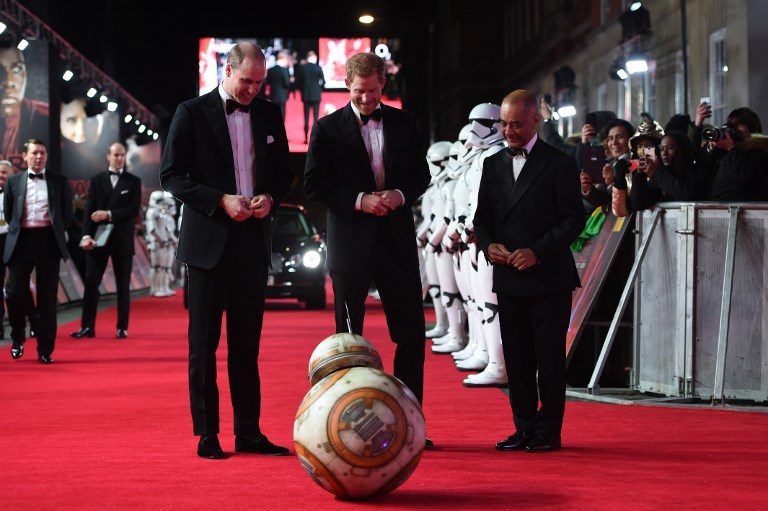ROYAL GESTURE. Britain's Prince William (L), Duke of Cambridge and Prince Harry are greeted by droid BB-8 as they arrive for the European Premiere of Star Wars: The Last Jedi at the Royal Albert Hall in London on December 12, 2017. Photo by Eddie Mulholland/AFP/POOL 