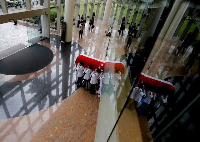 DEPARTURE. Military pallbearers carry the flag draped coffin of the late Mr Lee Kuan Yew out of the National University of Singapore University Cultural Centre after the state funeral for a private cremation in Singapore, 29 March 2015. Wallace Woon/EPA 
