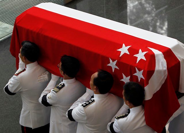 GOODBYE. Military pallbearers carry the flag draped coffin of the late Mr Lee Kuan Yew out of the National University of Singapore University Cultural Centre after the state funeral to a private cremation in Singapore, 29 March 2015. Wallace Woon/EPA 
