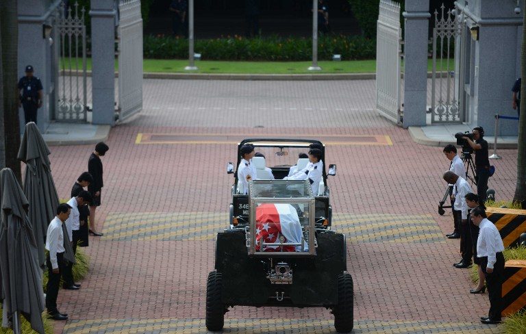 AT PARLIAMENT FOR THE LAST TIME. The body (C) of Singapore's former prime minister Lee Kuan Yew arrives at Parliament House where it will lie in state for public viewing ahead of his funeral in Singapore on March 25, 2015. Mohd Fyrol/AFP 