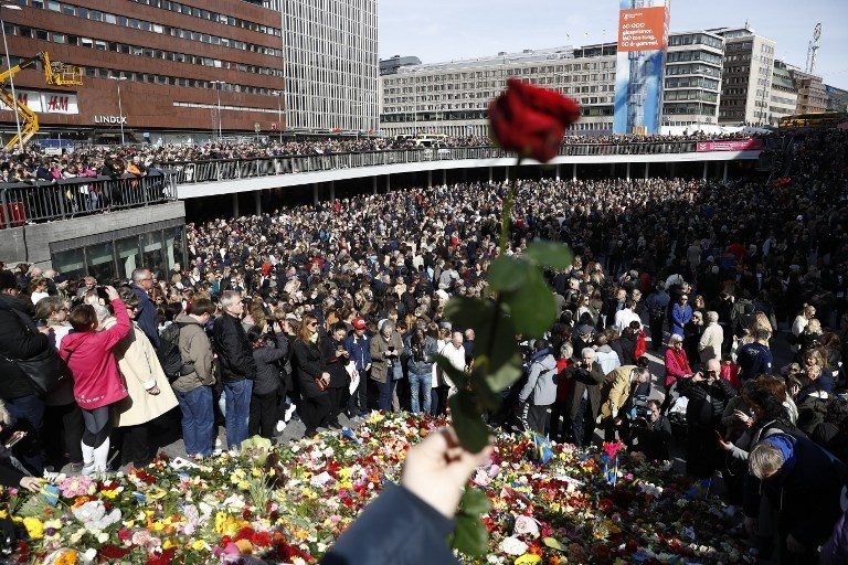 IN MOURNING. People attend a memorial ceremony on April 9, 2017, at Sergels Torg plaza in Stockholm, close to the point where a truck drove into a department store two days before. Photo by Odd Andersen/AFP     