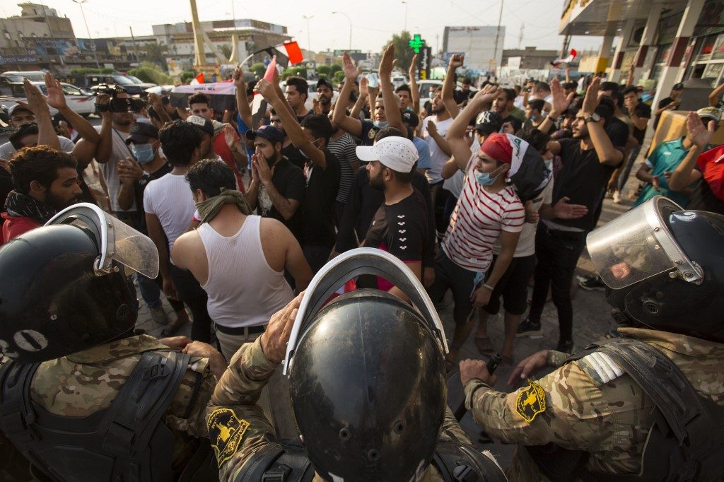 Facing pressure, Iraq ups probes into protest bloodshed