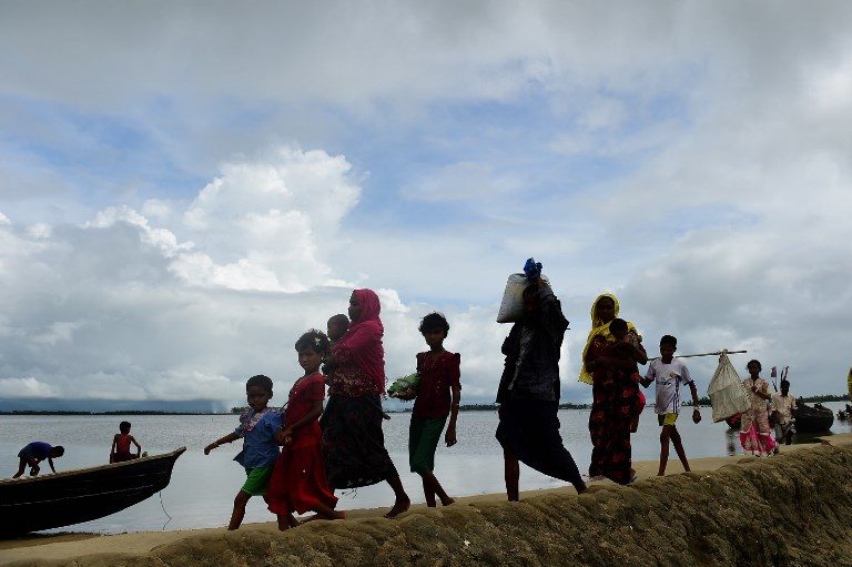 EXODUS. Rohingya Muslim refugees arrive from Myanmar after crossing the Naf river in the Bangladeshi town of Teknaf on September 12, 2017. Photo by Munir Uz Zaman/AFP  