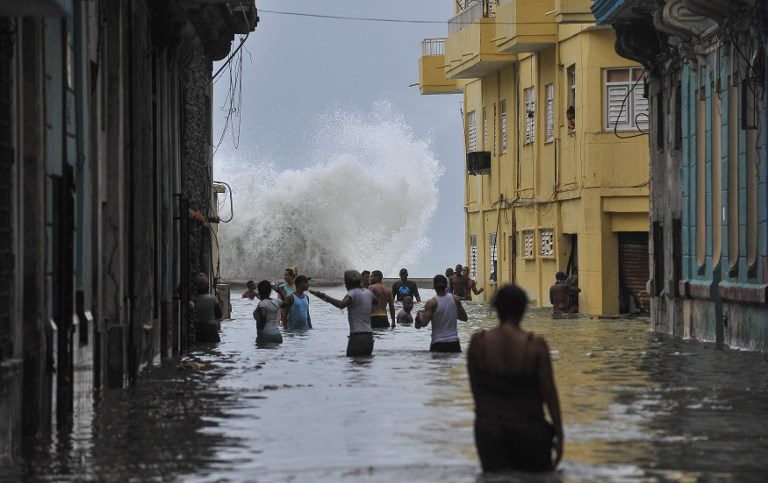 IRMA'S PATH. Residents wade through a flooded street in Havana as Hurricane Irma batters central Cuba on September 10, 2017. Photo by Yamil Lage/AFP  