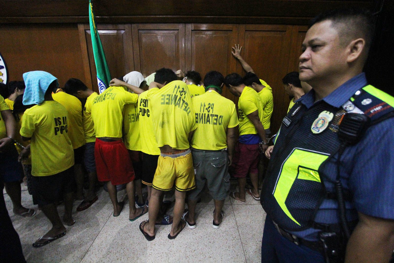 'FOR HUMAN RIGHTS.' The drug suspects are told to hide their faces and turn around during the press conference. Photo by Ben Nabong/Rappler 