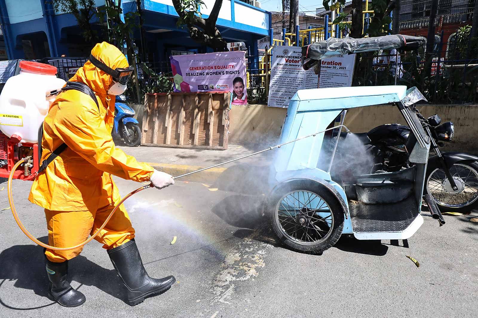 CORONAVIRUS RESPONSE. Quezon City Health workers disinfect the surroundings of a barangay in District 1. File photo by Darren Langit/Rappler 