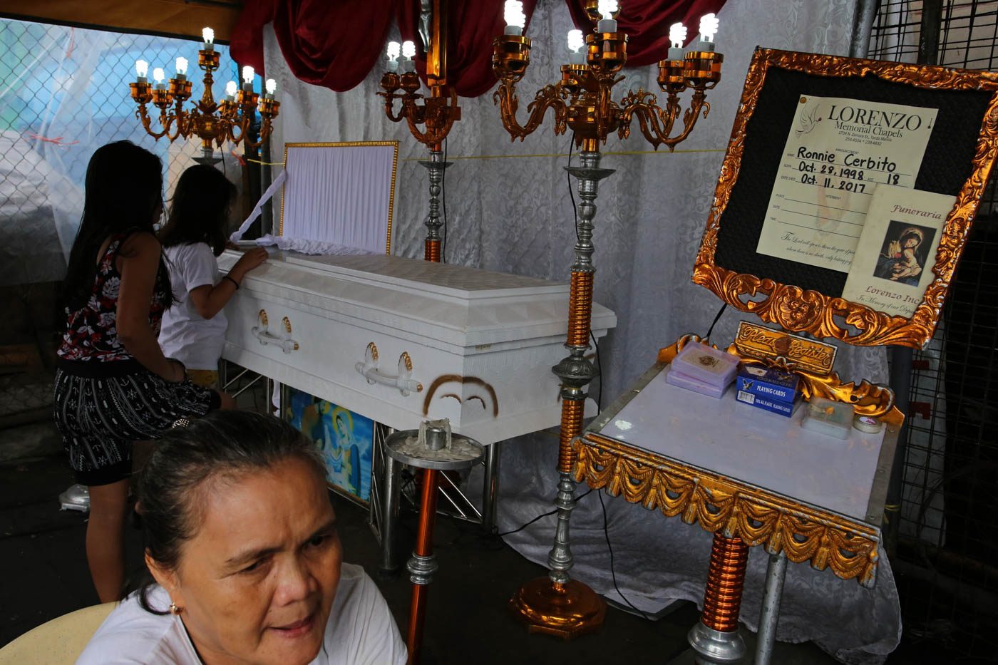 ANOTHER TEENAGER. Relatives and friends of Ronnie Cerbito pay their respects at his wake. He was abandoned as a child. His parents don't know that he is dead. Photo by Kimberly dela Cruz   