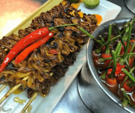 SPICY CHICKEN ISAW WITH CONFIT CHILIS. 