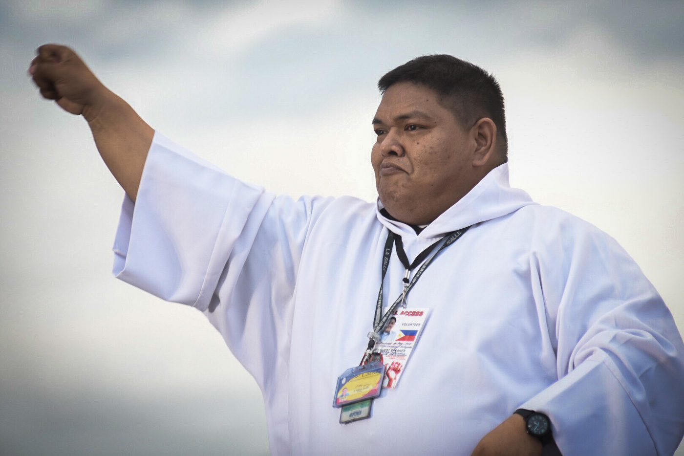 INTERPRETER. Father Patrick Ong interprets the messages for deaf-mute followers.
