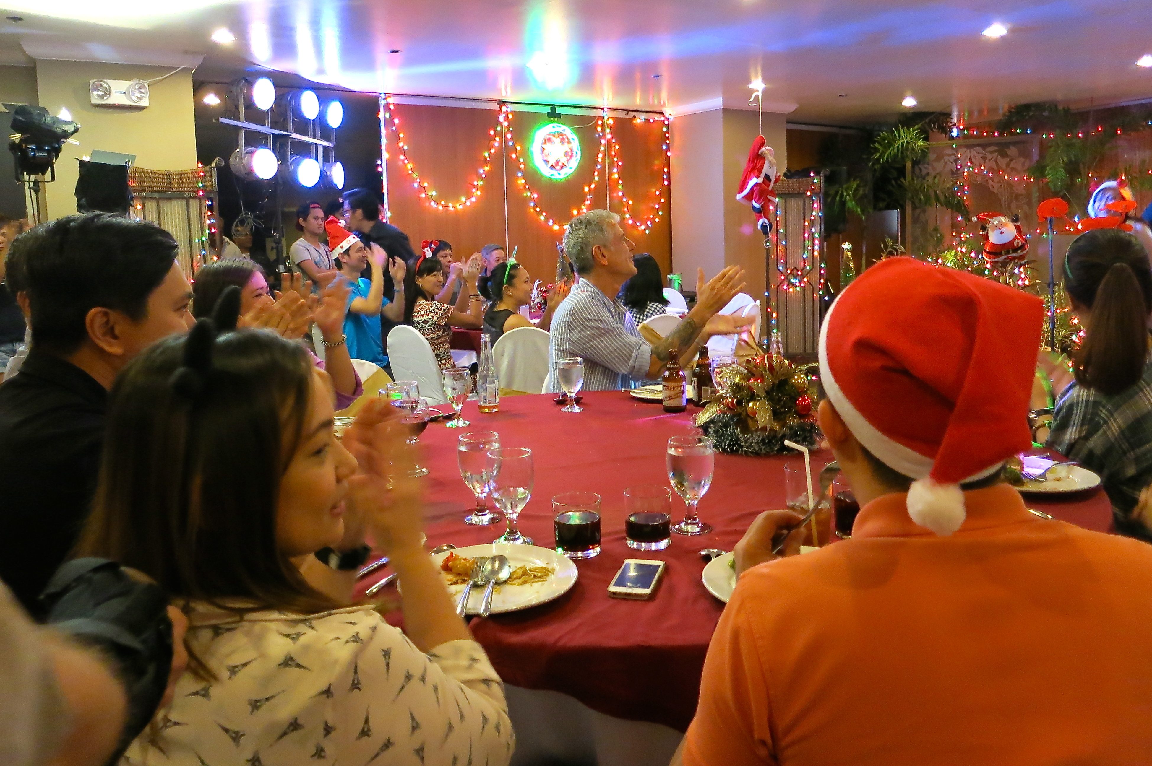 CHRISTMAS PARTY. Tony and the crowd applaud Regatta at the end of their set at a holiday office party in Manila. Photo courtesy of CNN  