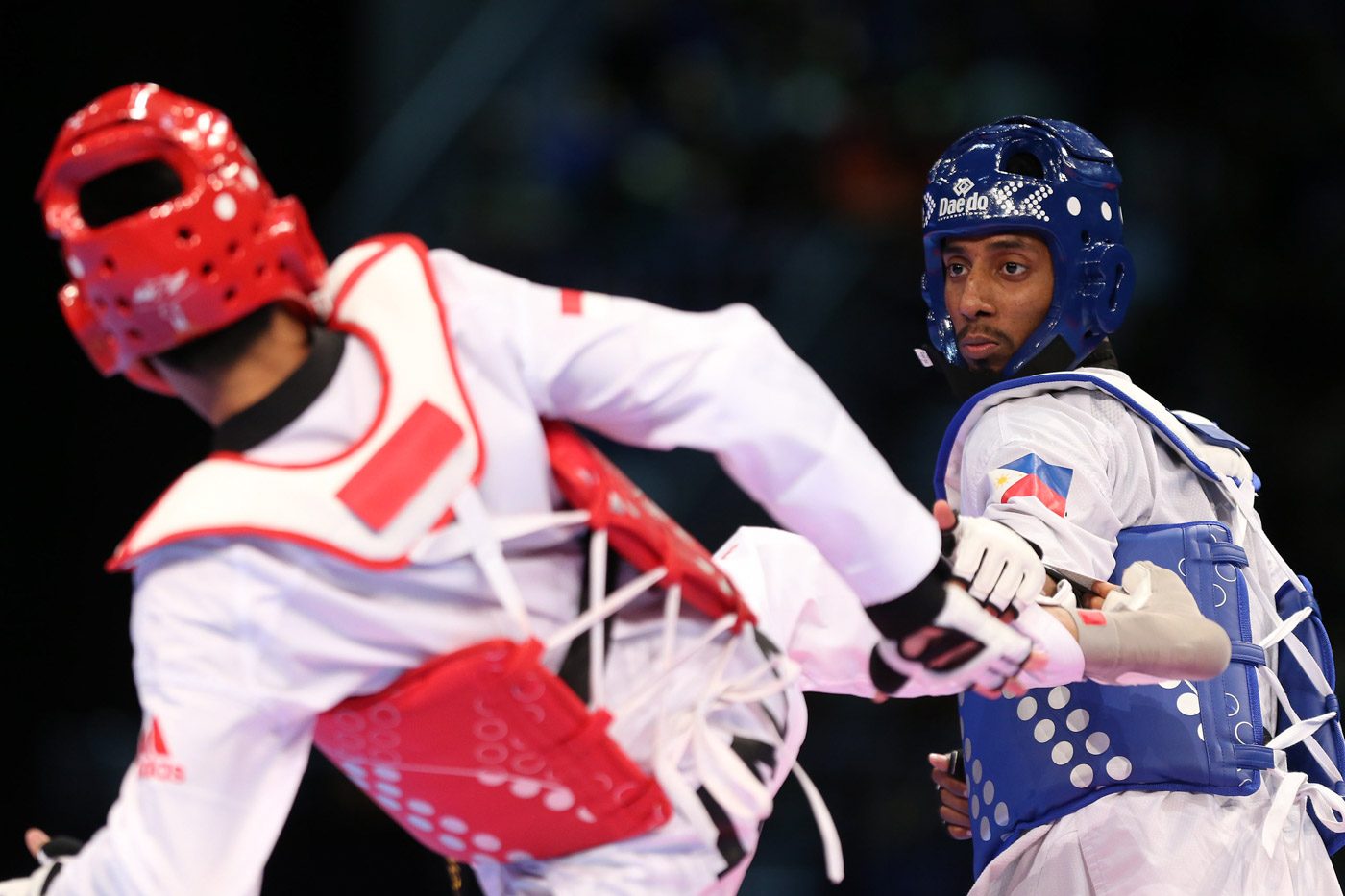 Samuel Thomas Harper Morrison of the Philippines battles Ardian Prayogo Dinggo of Indonesia in the finals of the men's -74kg of the 29th Southeast Asian Games taekwondo competition. Morrisson prevailed to win the gold medal. Photo from PSC-POC Media 