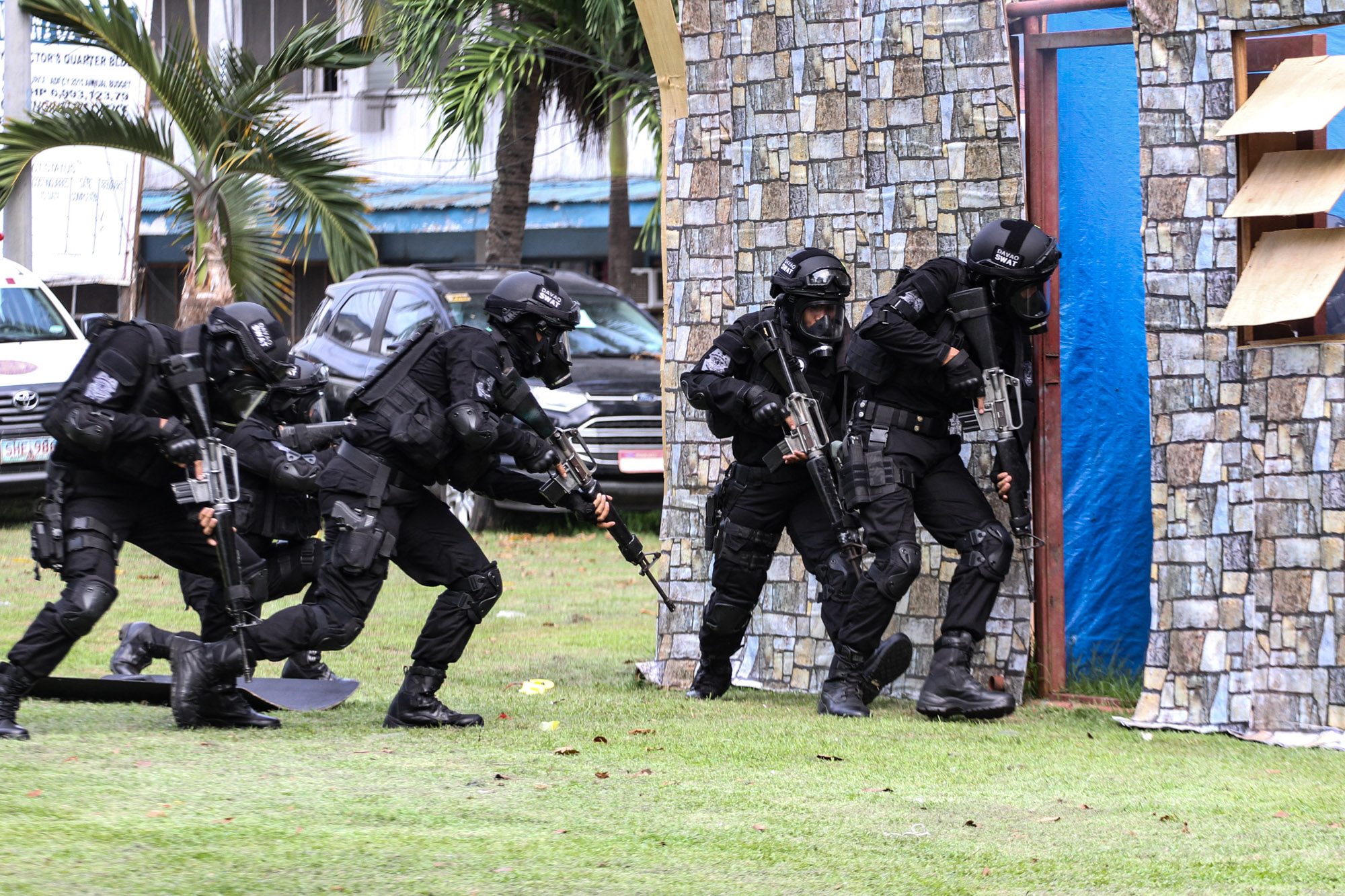 COMBAT-READY. SWAT members enter a simulation room, demonstrating their close quarters combat capability.  