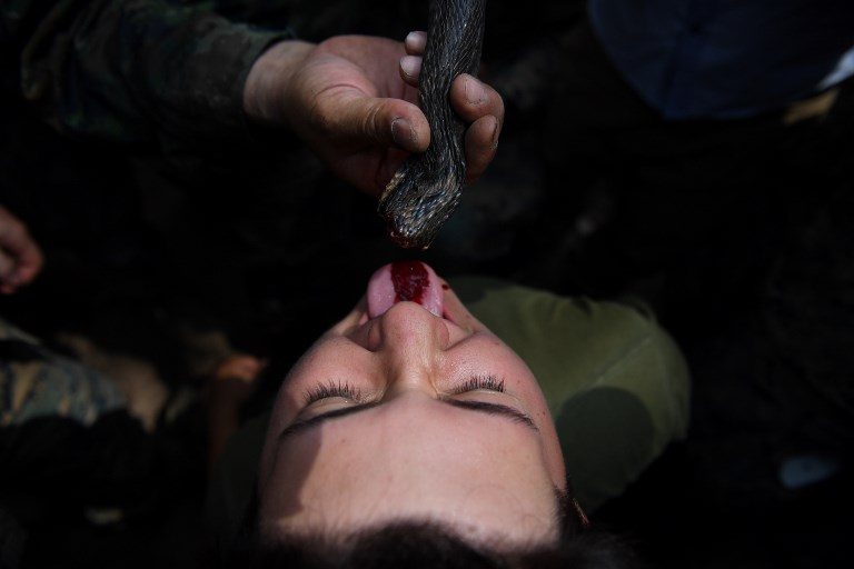 SURVIVAL TRAINING. A US Marine drinks snake blood during a jungle survival training with Thai soldiers in the joint 'Cobra Gold' military exercise in Chantaburi province on February 14, 2019. Photo by Lillian Suwanrumpha/AFP  