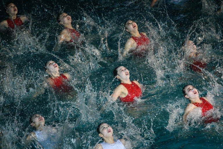 CELEBRATION. Swimmers perform in a synchronized swimming gala event celebrating late North Korean leader Kim Jong Il in Pyongyang on February 14, 2019. Photo by Ed Jones/AFP   